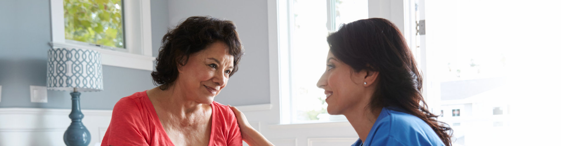 elderly woman in bed and her caregiver